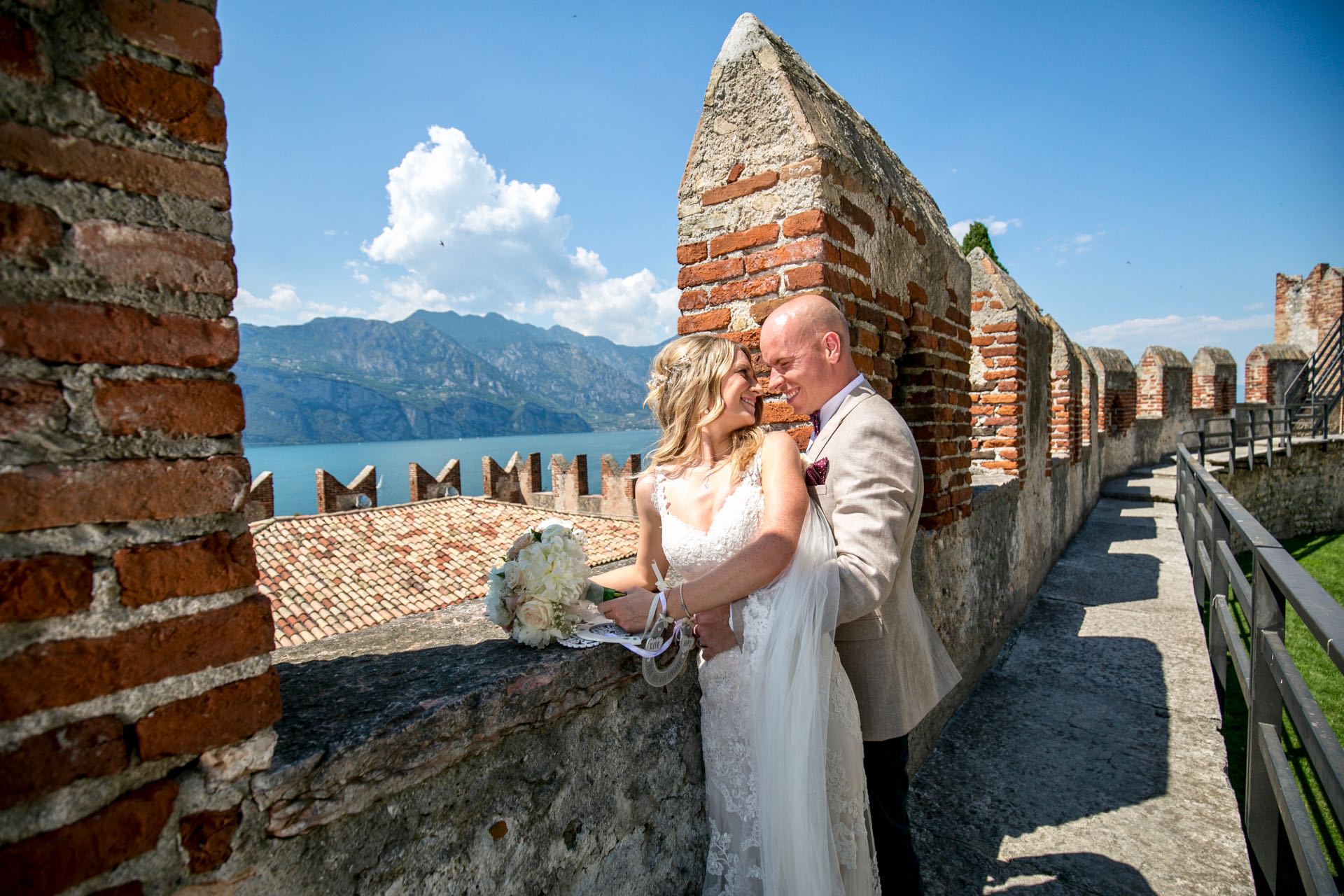 Couple posing at Malcesine Castle in Lake Garda.